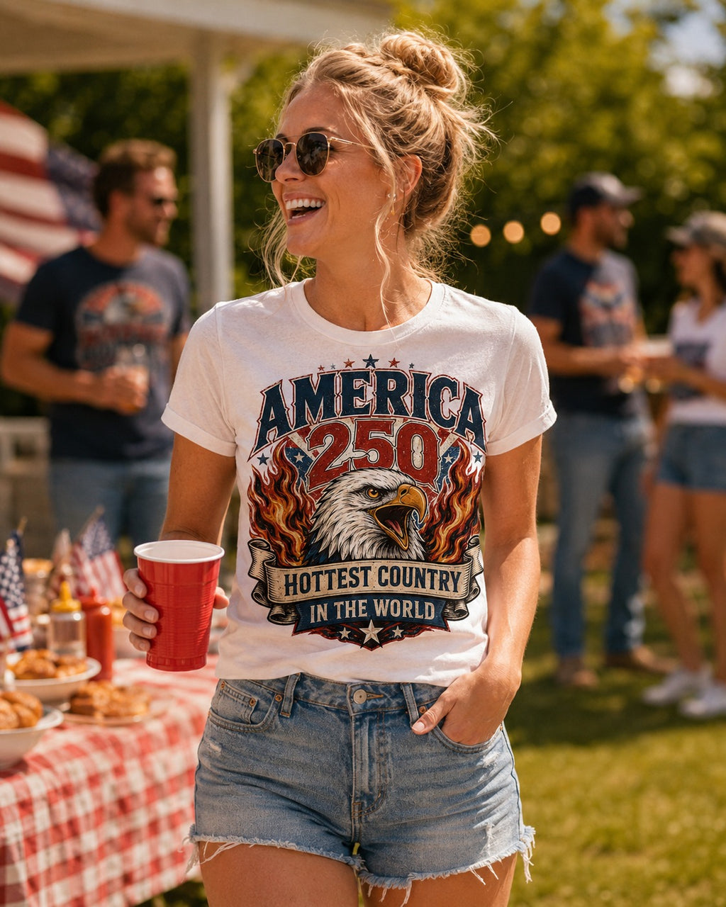 Model wearing White Fiery Eagle America 250 patriotic t-shirt at summer BBQ